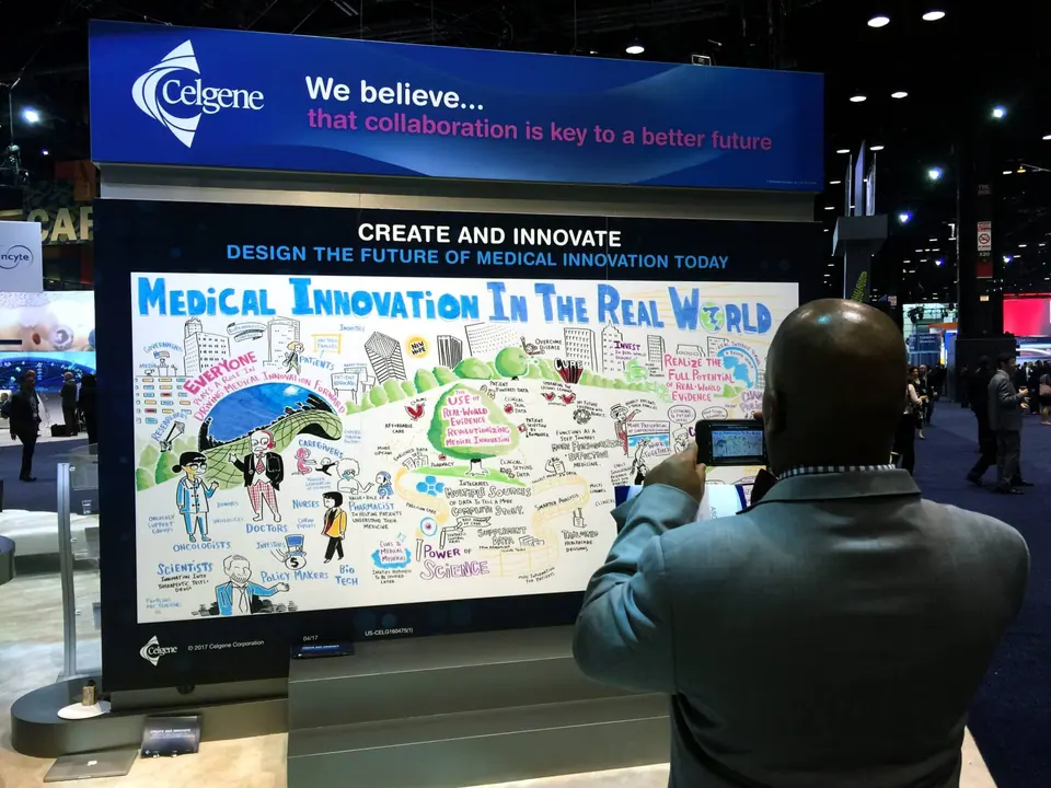Man takes photo at Graphic recording and healthcare tradeshow booth