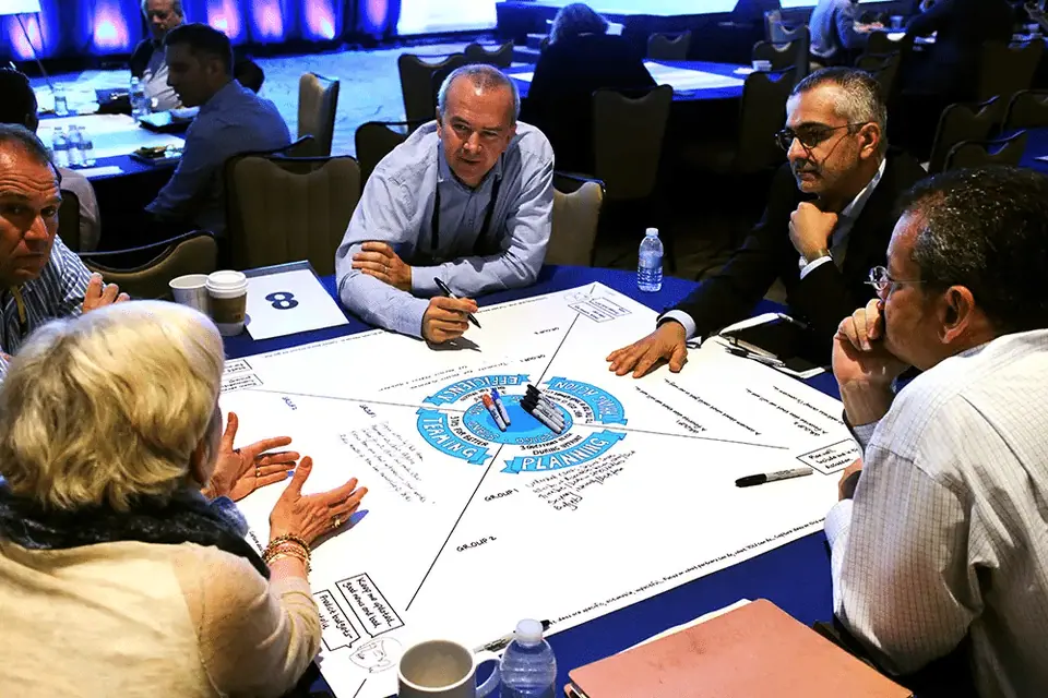 A group of event attendees participating in conversation and visualization.