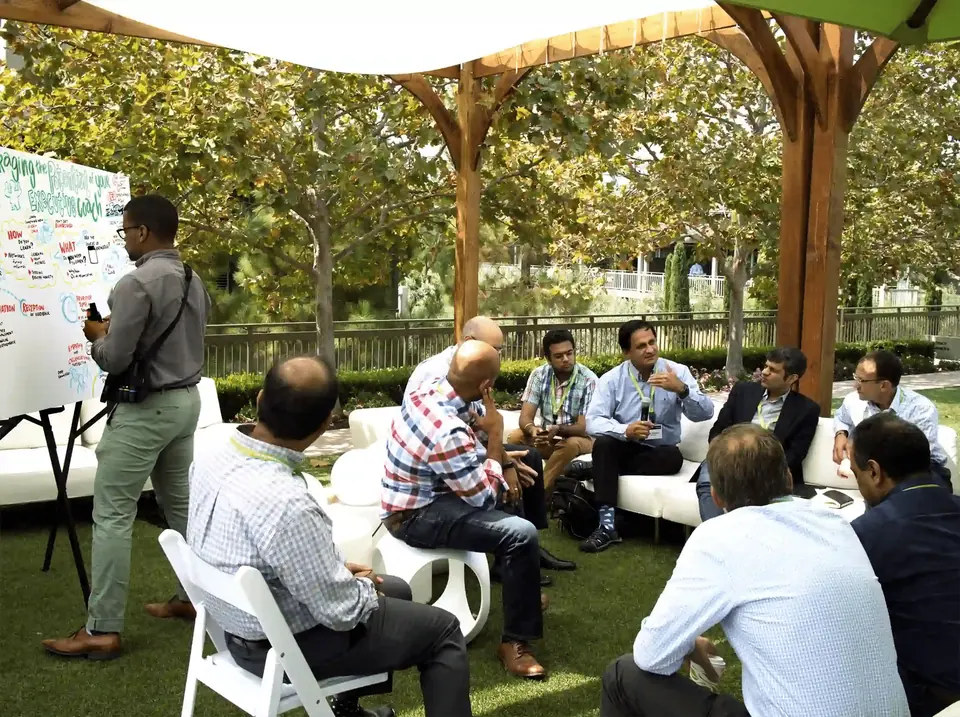 An individual contributing to visual scribing during a meeting.