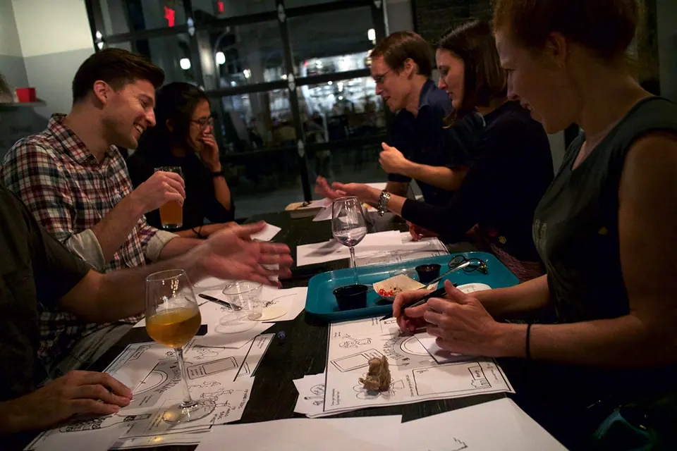 ImageThink graphic recording hosted mageDrink drink and draw event at Bergn in Brooklyn NY. Group of excited attendees drawing games.