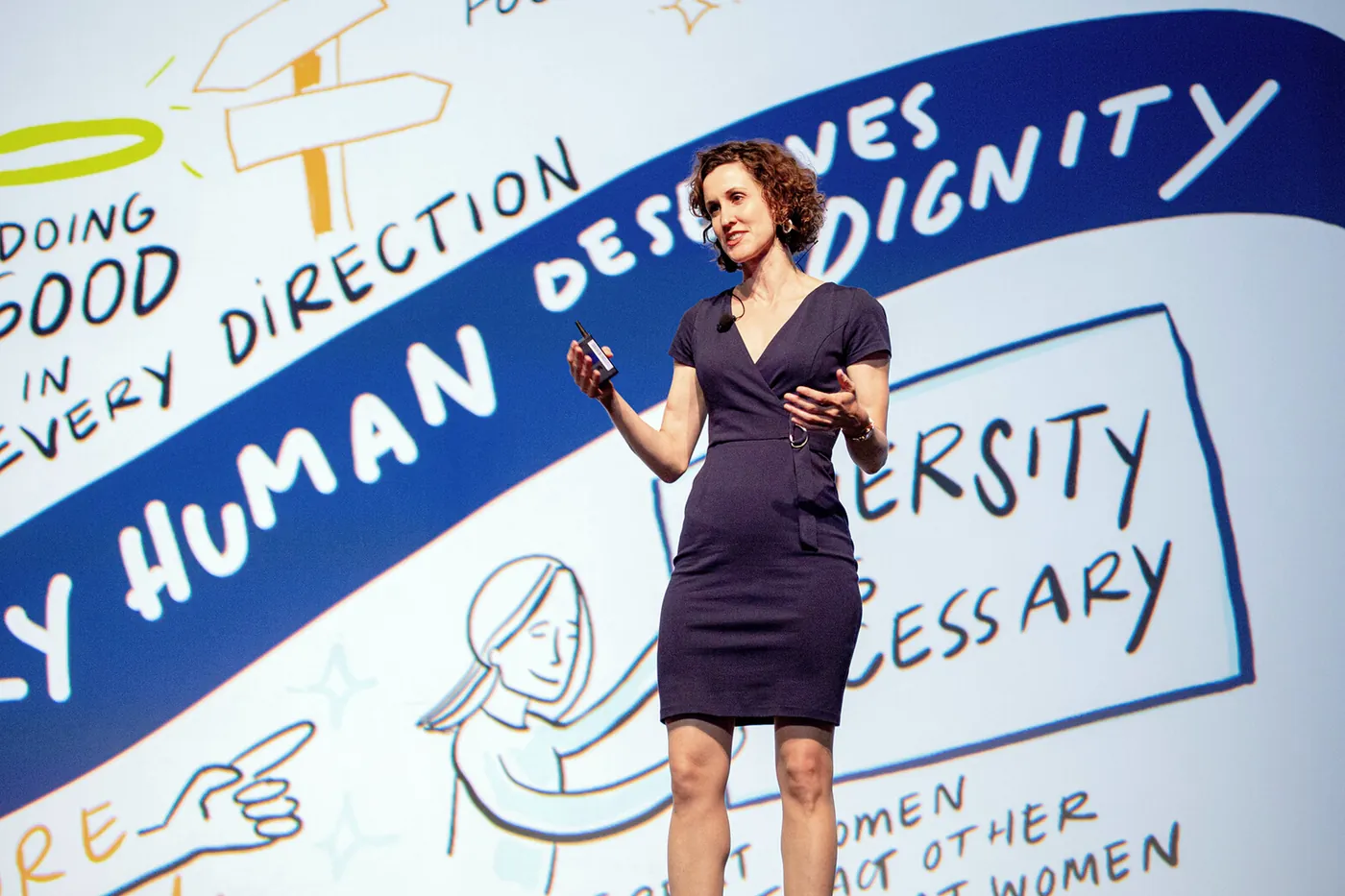 ImageThink founder and CEO Nora Herting gives a keynote at WBENC 2019 in front of a large graphic recording.