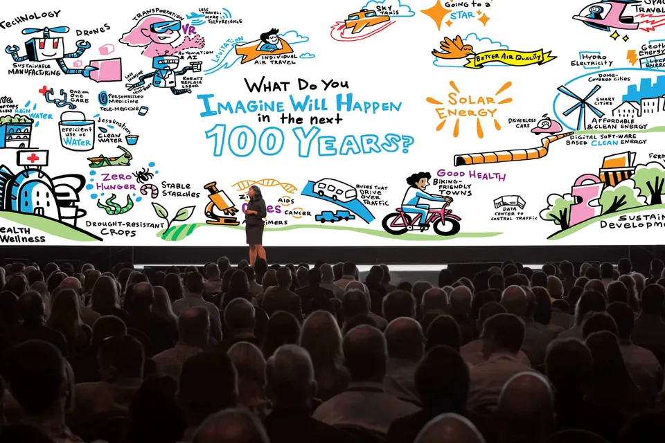 A conference keynote with graphic recording projected behind the speaker