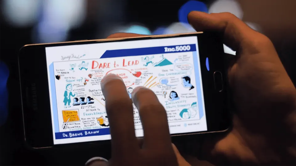 A person viewing drawn visual notes on a smartphone