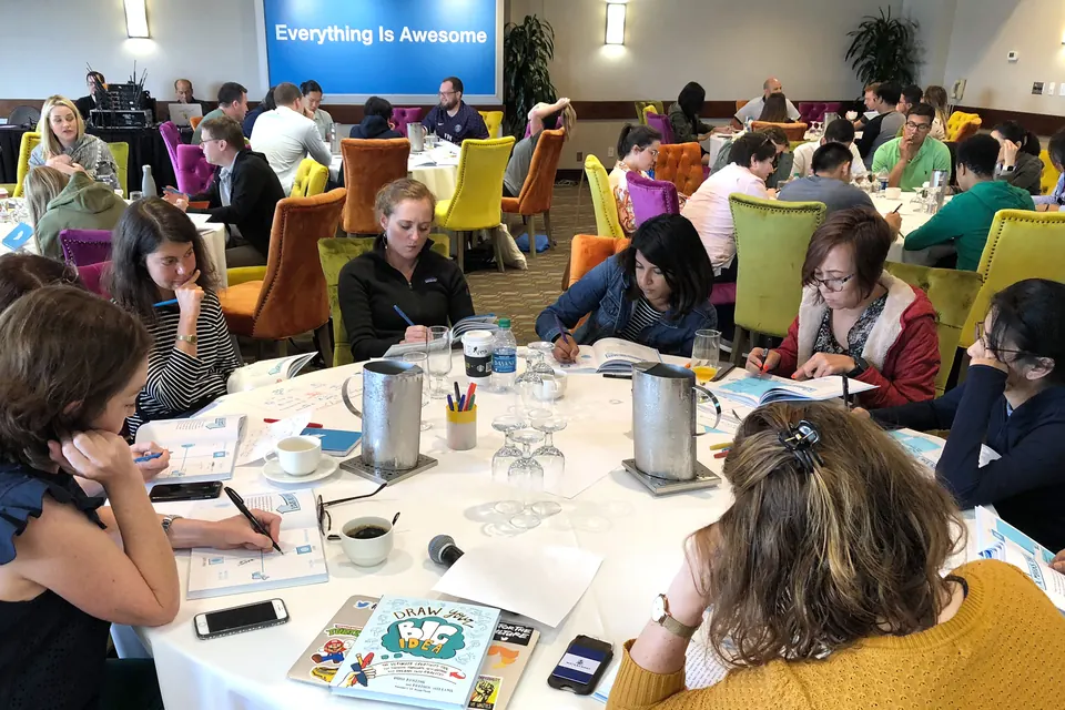 Workshop participants working in groups with Draw Your Big Idea exercises